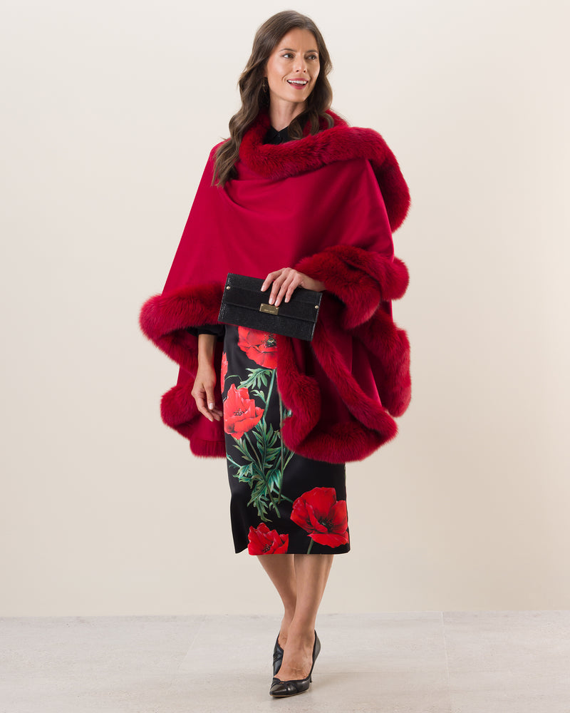 Woman Wearing Fur Trimmed Cape in red