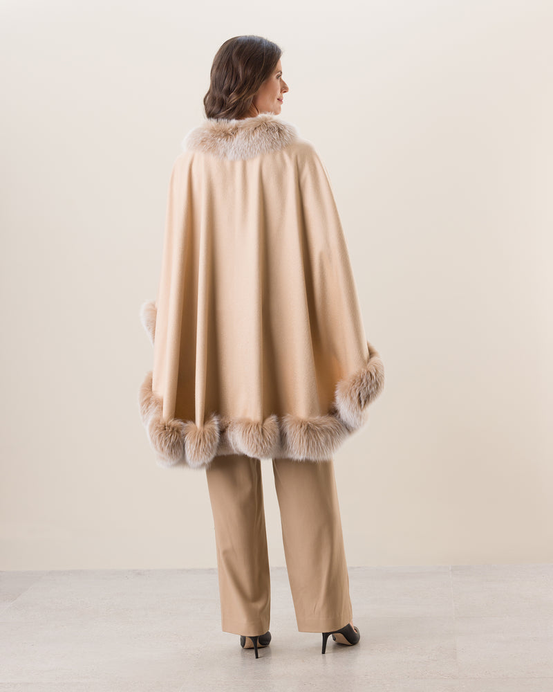 Woman Wearing Fur Trimmed Cape in Blonde