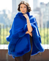 Woman wearing a Cervinia Cashmere Cape with real fur trim in Electric Blue 