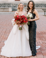 bride wearing white capri cashmere fur trimmed shawl next to bridesmaid