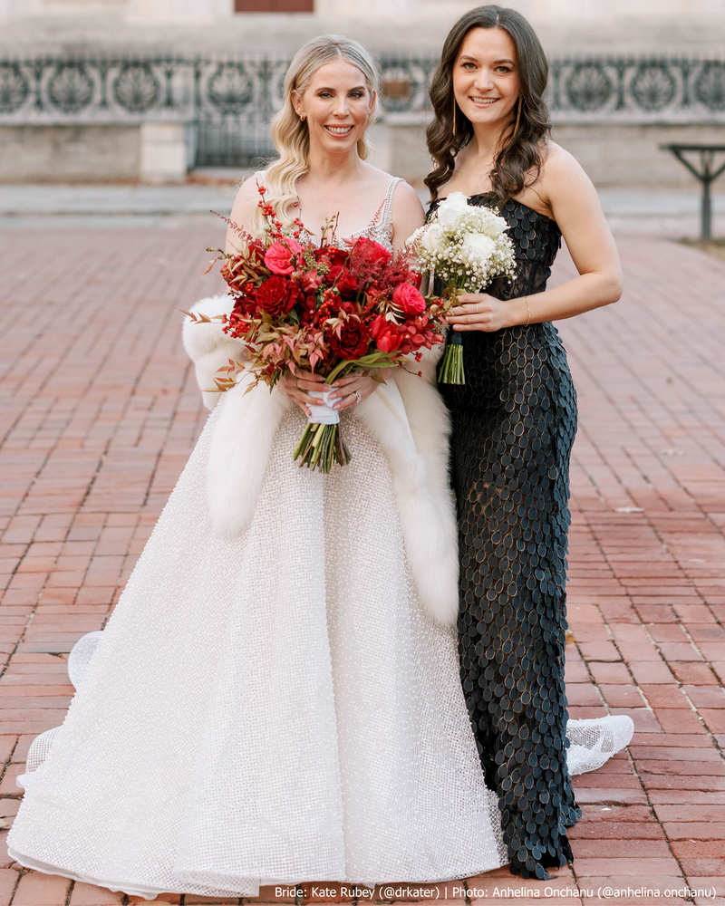 bride wearing white capri cashmere fur trimmed shawl next to bridesmaid