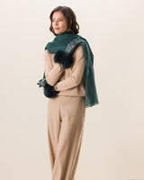 Woman wearing Mano fur trimmed leather glove in emerald