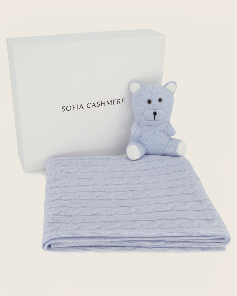 Cashmere Baby blanket with teddy bear in soft blue and Sofia Cashmere logo on a light background
