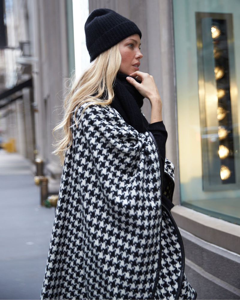 Woman Wearing Alpaca Wool Cape with Leather trim in Black and White Houndstooth Pattern.
