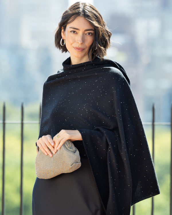 Woman wearing Radiant Cashmere Sequin Wrap in black holding a handbag