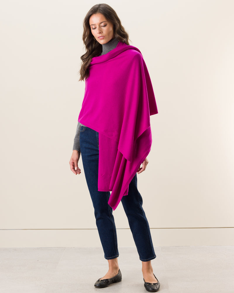 Woman wearing Voyage Cashmere Travel Wrap in Fuschia