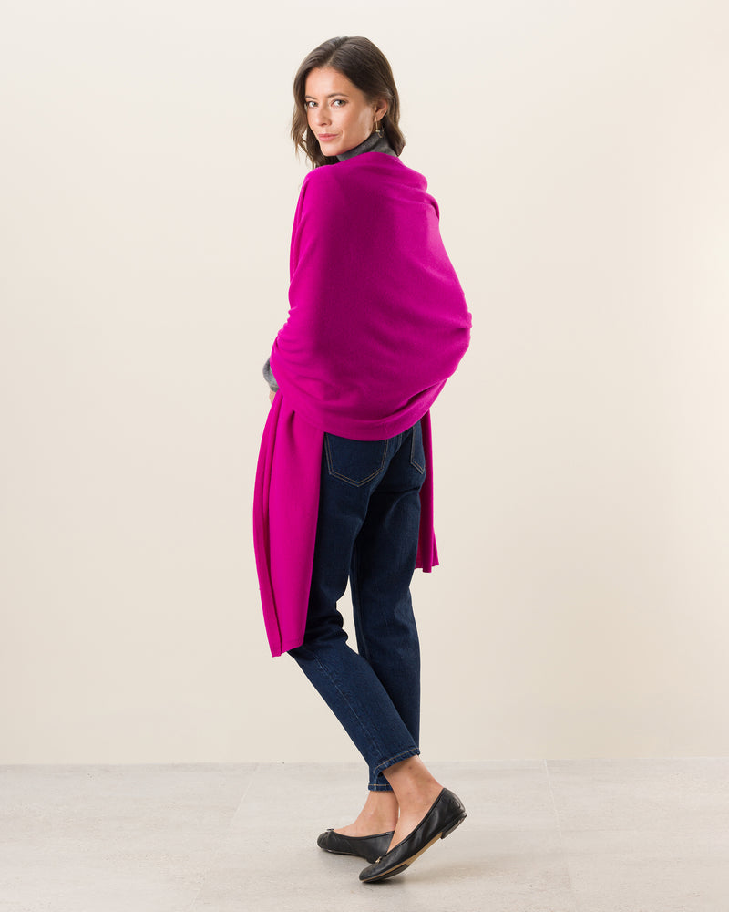 Woman wearing Voyage Cashmere Travel Wrap in Fuschia