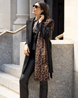 Woman wearing Lightweight cashmere wrap in camel leopard over her shoulder