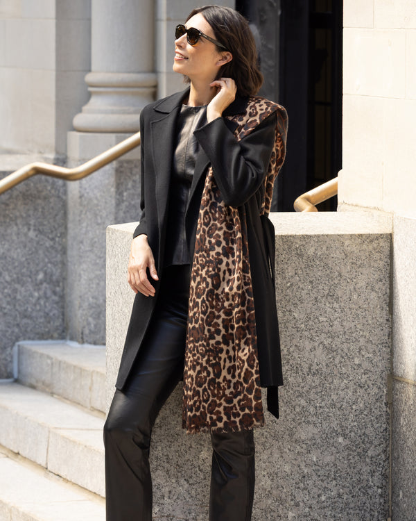 Woman wearing Lightweight cashmere wrap in camel leopard over her shoulder