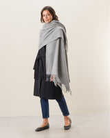 Woman wearing Cashmere water weave wrap with fringe in grey