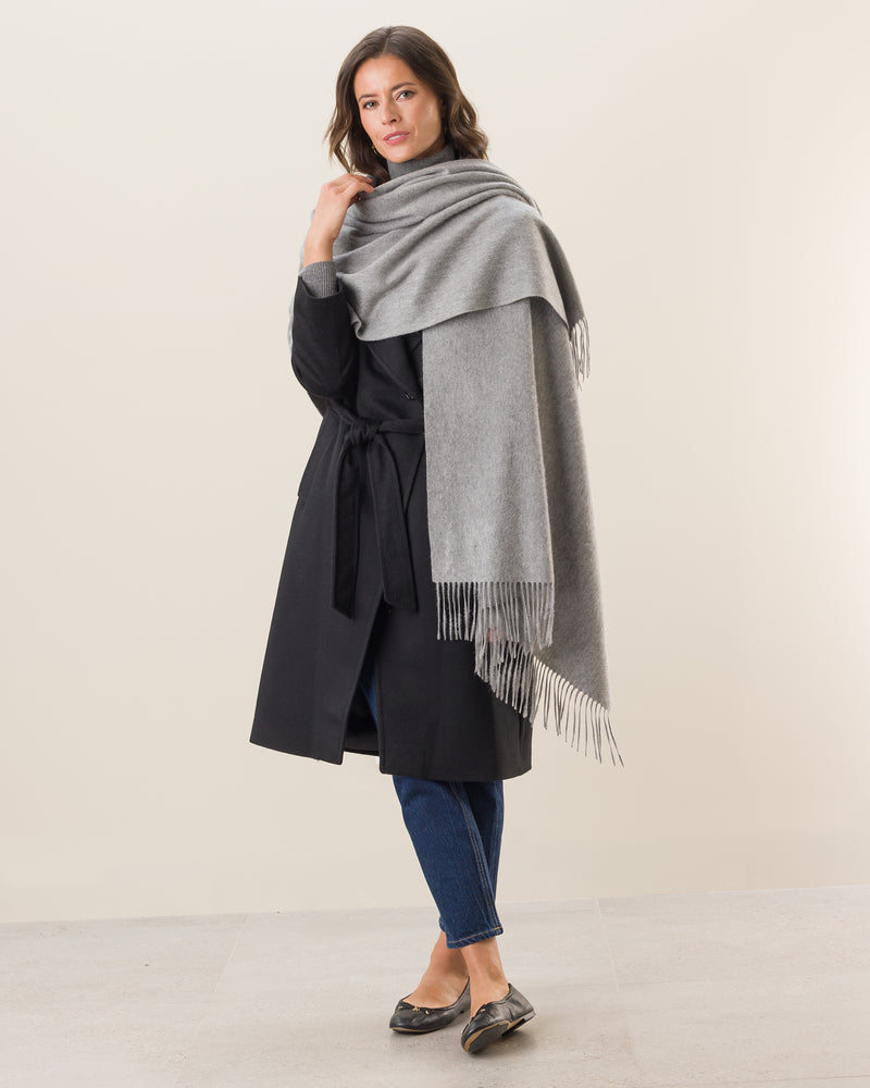 Woman wearing Cashmere water weave wrap with fringe in grey
