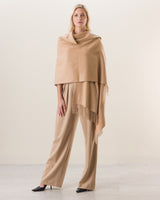 Woman wearing Cashmere water weave wrap with fringe in camel
