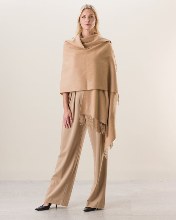 Woman wearing Cashmere water weave wrap with fringe in camel