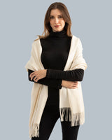 Woman wearing Cashmere water weave wrap with fringe in ivory