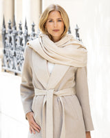 Cashmere water weave wrap with fringe in oat  with blurred background