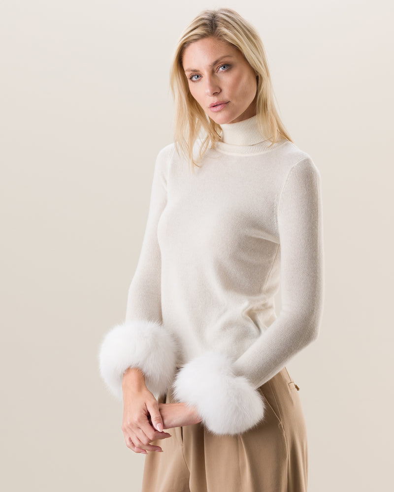 Woman wearing Cashmere Turtleneck with Finnish fur Cuffs in ivory