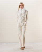 Woman wearing Wrap sweater with fur collar in Ivory