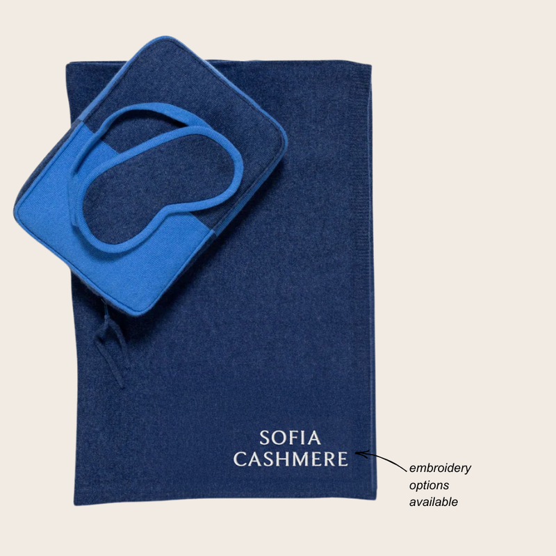 navy blue and bright blue travel set with pillow and blanket and sleep mask with Sofia Cashmere embroidered in corner; note: embroidery options available