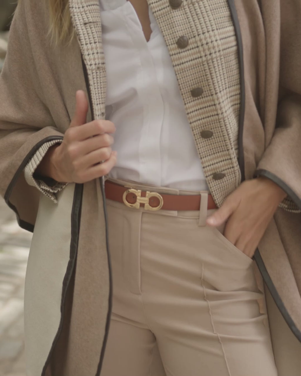 woman walking in the city wearing sofia cashmere reversible leather trimmed cashmere cape in  Oat/Grey