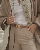 woman walking in the city wearing sofia cashmere reversible leather trimmed cashmere cape in  Oat/Grey