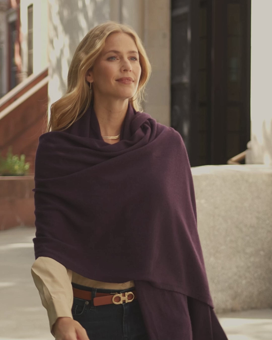 woman walking city streets wearing purple colored cashmere travel wrap