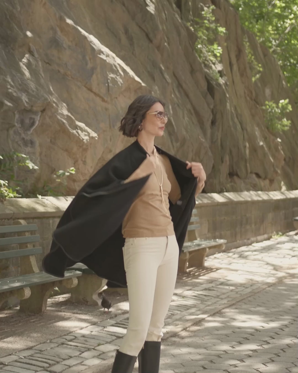 woman walking on city street wearing sofia cashmere Reversible Cashmere Cape with Leather trim in Black/Black