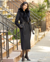 Woman Wool Cashmere Blend Maxi Wrap coat with Oversized Finland Fur Shawl Collar  in Black standing on a city street.
