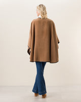 Woman Wearing Alpaca Wool Cape with Leather trim in camel, back view