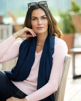 model wearing a dark colored wrap and Pura Baby Cashmere V-Neck Sweater in petal pink