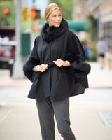 model wearing Frostmere Belted Cashmere Cape in black on street