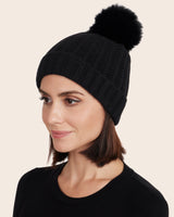 woman wearing cashmere Tuck Stitched Hat with Finland Fur pompom in black