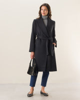 woman wearing carmela belted wrap cashmere coat in black