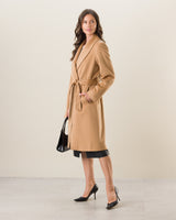 Woman wearing Carmela Belted Wrap cashmere Coat in camel