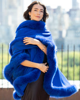 Close up of woman wearing a Cervinia Cashmere Cape with real fur trim in Electric Blue 