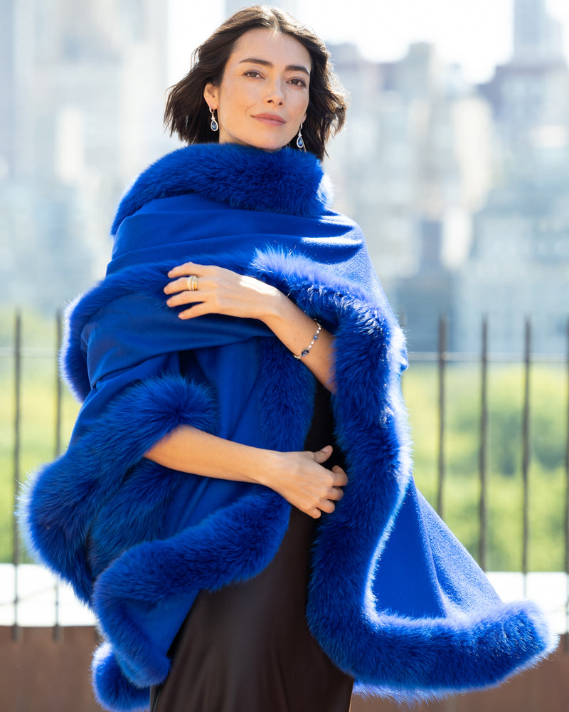 Close up of woman wearing a Cervinia Cashmere Cape with real fur trim in Electric Blue 