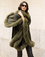 Woman wearing a Cashmere cape coat with real Fur trim in Olive