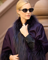 Woman wearing currant multi silver fur trimmed cervinia standing on a stoop, close up