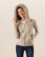 Woman wearing Cashmere zip sweater with fur trimmed hood in  Oatmeal