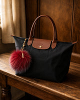 Red tri-color Pom Keychain on bag