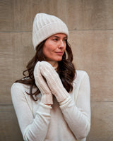 woman wearing Chunky Tuck Stitched Cuffed cashmere Hat in Ivory
