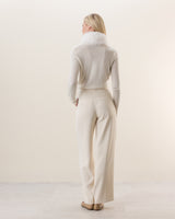 Woman wearing Wrap sweater with fur collar in Ivory
