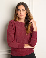 Model holding her her while wearing Stella Lurex Boat Neck Sweater in bordeaux