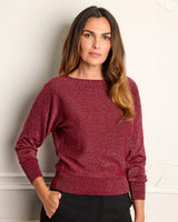 Model with her hand in her pocket while wearing Stella Lurex Boat Neck Sweater in bordeaux