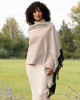Woman wearing a Cashmere Wrap with Leather Fringe in Oatmeal in an outdoor setting