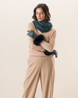 Woman wearing Mano fur trimmed leather glove in emerald