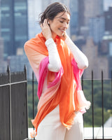 woman smiling and wearing Lightweight Cashmere Wrap in Orange Ombre 