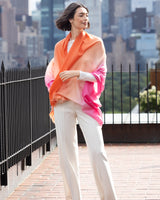 Woman standing on city rooftop and wearing wearing Lightweight Cashmere Wrap in Orange Ombre 