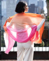 Woman's back holding wearing Lightweight Cashmere Wrap in Orange Ombre 