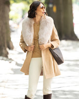 Woman wearing Alpaca Blend Wrap Short coat with Oversized Finland Fur Shawl Collar in Blonde in an urban setting