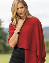 Woman wearing a red wrap/shawl with sequins outdoors with a natural background